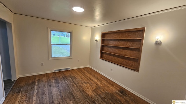 empty room with wood finished floors and baseboards