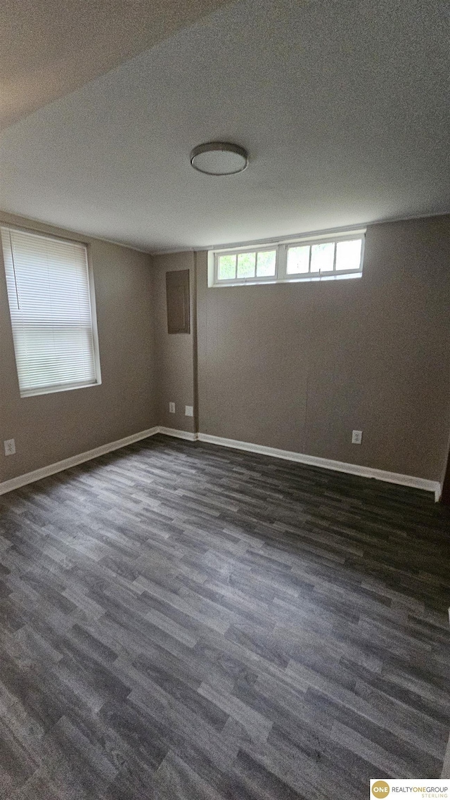 unfurnished room featuring dark wood finished floors and baseboards