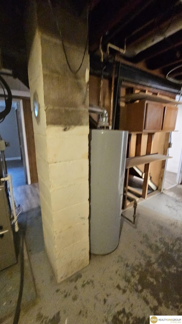 unfinished below grade area featuring water heater