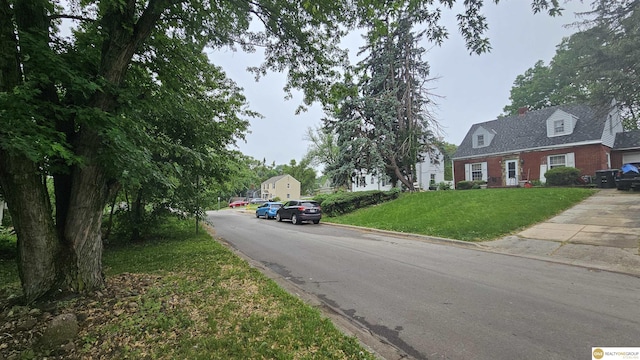 view of asphalt road with curbs