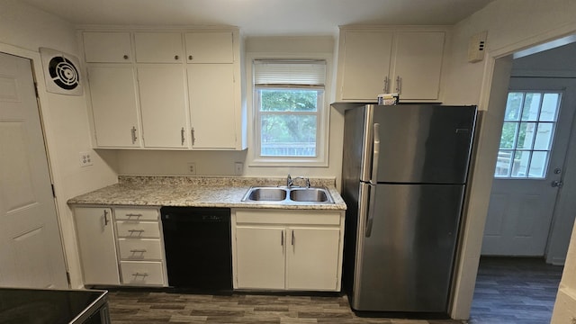 kitchen with freestanding refrigerator, dishwasher, a sink, and dark wood-type flooring