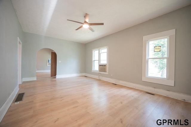 616 N 4th St, Beatrice, NE 68310 - spare room with arched walkways, a ceiling fan, light wood finished floors, and baseboards