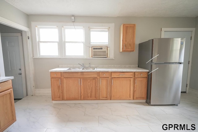 616 N 4th St, Beatrice, NE 68310 - kitchen featuring freestanding refrigerator, a sink, light marble finish flooring, and light countertops