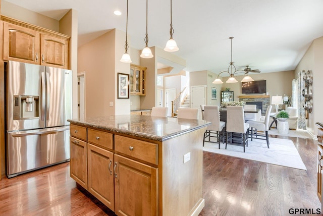 7320 S 169th St, Omaha, NE 68136 - kitchen featuring stainless steel fridge, a center island, stone countertops, and dark wood-style flooring