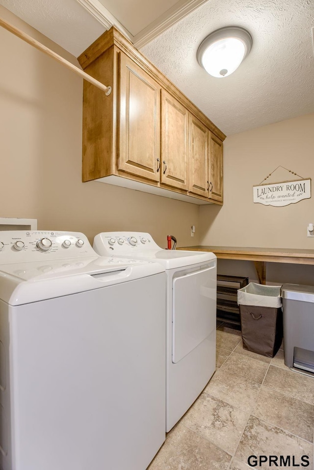 7320 S 169th St, Omaha, NE 68136 - laundry area with cabinet space, washer and clothes dryer, and a textured ceiling