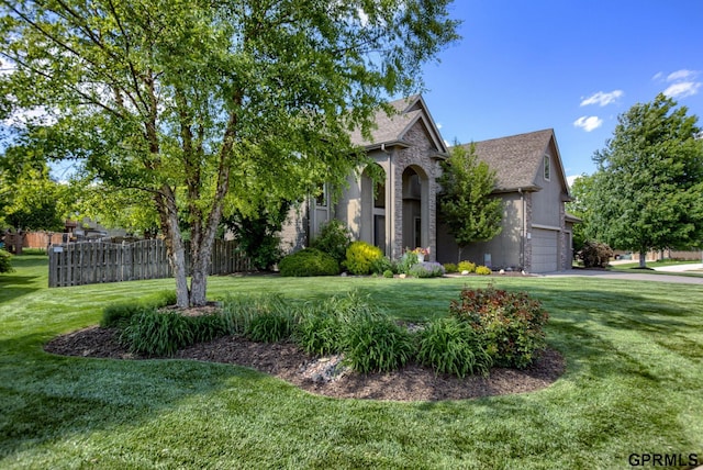 7320 S 169th St, Omaha, NE 68136 - view of property hidden behind natural elements featuring a garage and a shingled roof