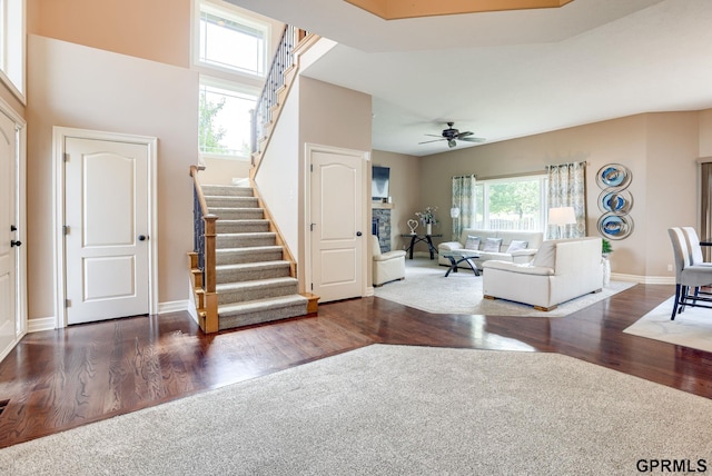 7320 S 169th St, Omaha, NE 68136 - living room featuring stairway, wood finished floors, a ceiling fan, and baseboards