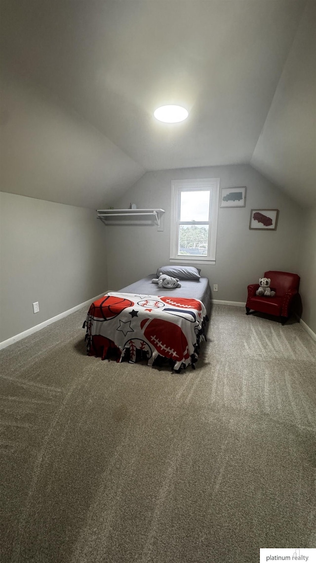 bedroom featuring lofted ceiling, carpet floors, and baseboards