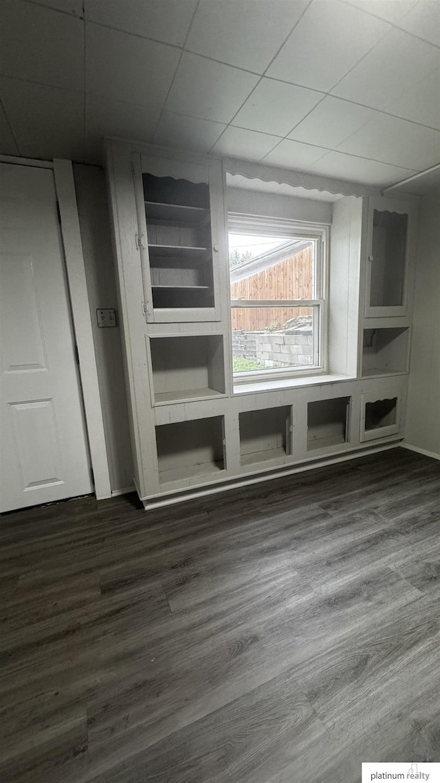 detailed view of wood finished floors and a paneled ceiling