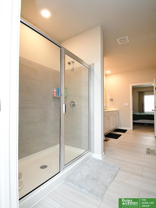 bathroom featuring a stall shower, ensuite bathroom, vanity, and recessed lighting