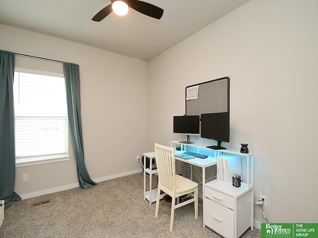 office space with a ceiling fan, baseboards, and light colored carpet