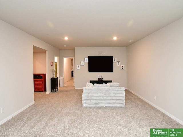 living area with light colored carpet, recessed lighting, and baseboards