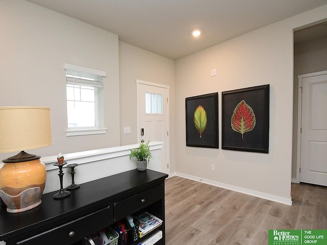 foyer entrance featuring light wood-style flooring, recessed lighting, and baseboards