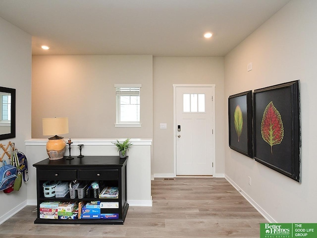 entryway featuring wood finished floors, recessed lighting, and baseboards