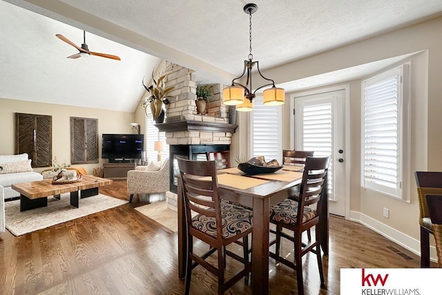 7815 Maui Cir, Papillion, NE 68046 - dining space with wood finished floors, healthy amount of natural light, a textured ceiling, baseboards, and ceiling fan