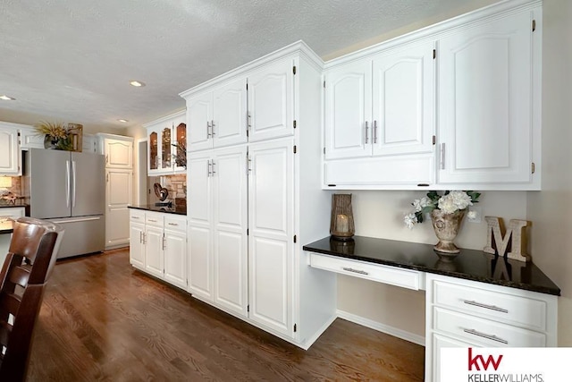 7815 Maui Cir, Papillion, NE 68046 - kitchen featuring freestanding refrigerator, dark wood finished floors, dark countertops, white cabinets, and recessed lighting