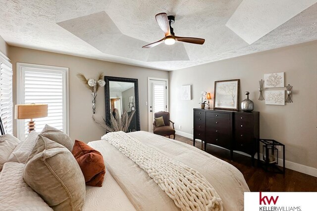 7815 Maui Cir, Papillion, NE 68046 - bedroom with a textured ceiling, baseboards, dark wood-type flooring, and ceiling fan