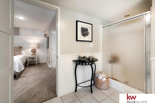 7815 Maui Cir, Papillion, NE 68046 - bathroom with a shower stall, wainscoting, and tile patterned floors