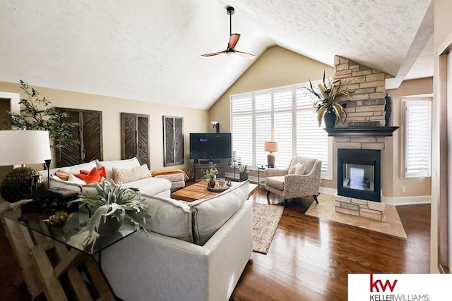 7815 Maui Cir, Papillion, NE 68046 - living room featuring a textured ceiling, lofted ceiling, wood finished floors, a ceiling fan, and a fireplace