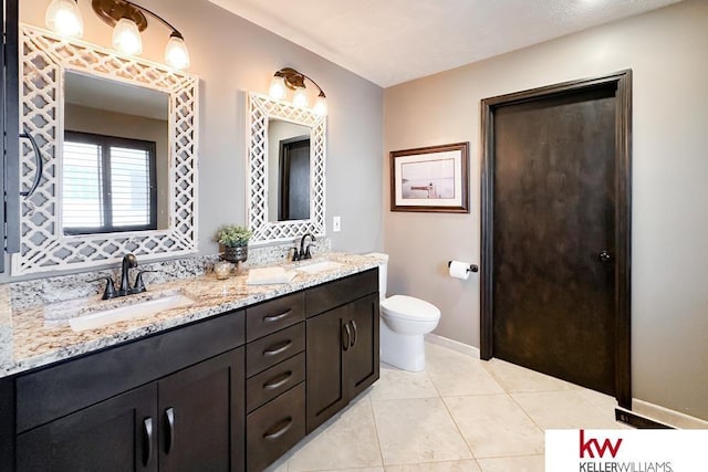 7815 Maui Cir, Papillion, NE 68046 - bathroom with toilet, baseboards, tile patterned flooring, and double vanity