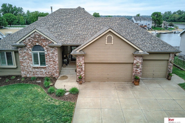 7815 Maui Cir, Papillion, NE 68046 - traditional-style house with a shingled roof, brick siding, concrete driveway, and an attached garage