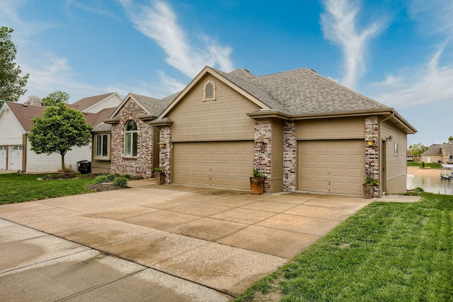 7815 Maui Cir, Papillion, NE 68046 - traditional home with an attached garage, brick siding, a front lawn, a shingled roof, and concrete driveway