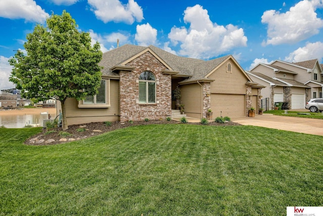 7815 Maui Cir, Papillion, NE 68046 - view of front of home with driveway, brick siding, a shingled roof, and a front lawn