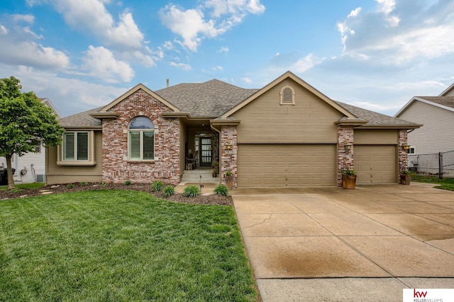7815 Maui Cir, Papillion, NE 68046 - view of front of property with a garage, concrete driveway, a shingled roof, and brick siding