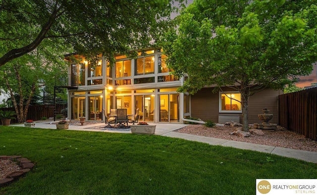19882 Chicago St, Elkhorn, NE 68022 - rear view of house featuring a patio area and an outdoor fire pit