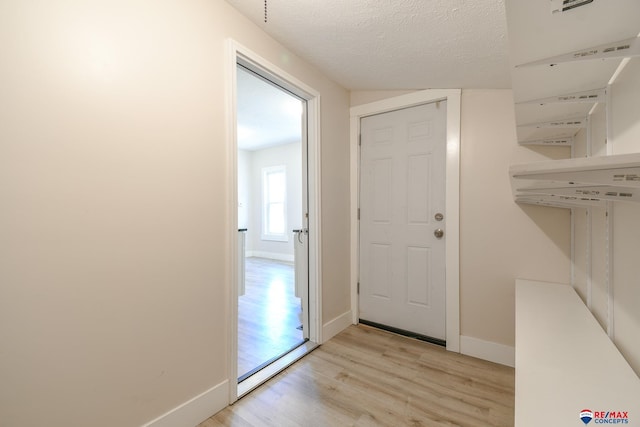 3021 N St, Lincoln, NE 68510 - entryway featuring light wood-type flooring, baseboards, and a textured ceiling
