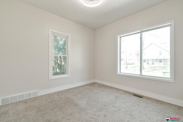 3021 N St, Lincoln, NE 68510 - spare room featuring carpet flooring and baseboards