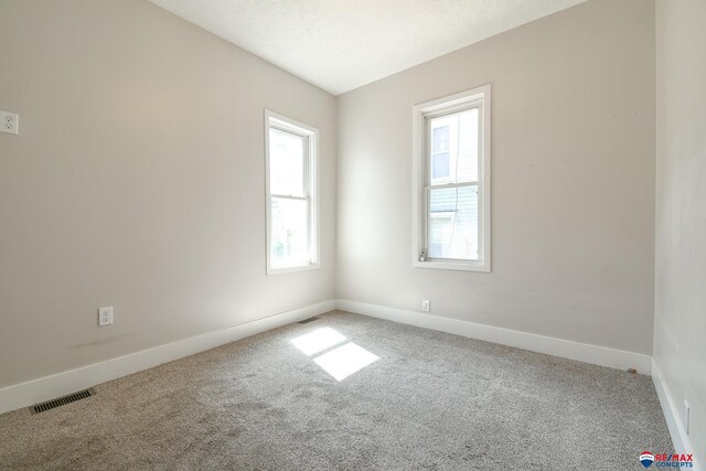 3021 N St, Lincoln, NE 68510 - spare room featuring carpet and baseboards