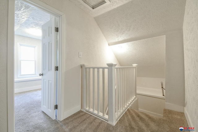 3021 N St, Lincoln, NE 68510 - stairs with a textured ceiling, carpet floors, a textured wall, lofted ceiling, and baseboards