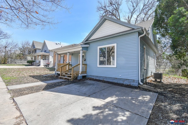 3021 N St, Lincoln, NE 68510 - view of front facade featuring covered porch and central AC