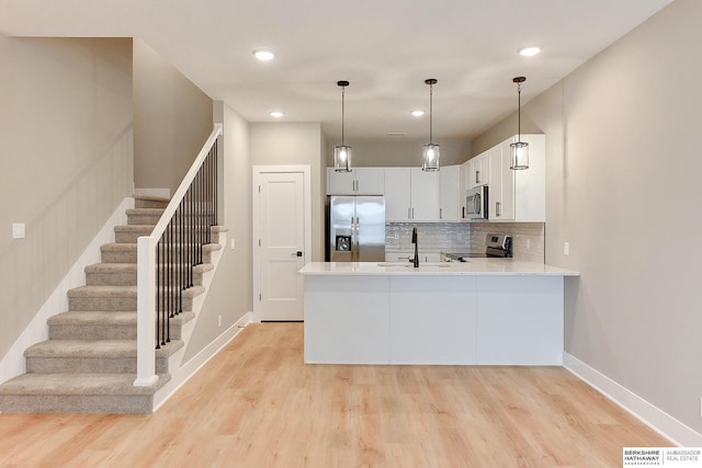 1917 Dahlman Rows Plz, Omaha, NE 68108 - kitchen with stainless steel appliances, tasteful backsplash, a sink, light wood-style flooring, and recessed lighting