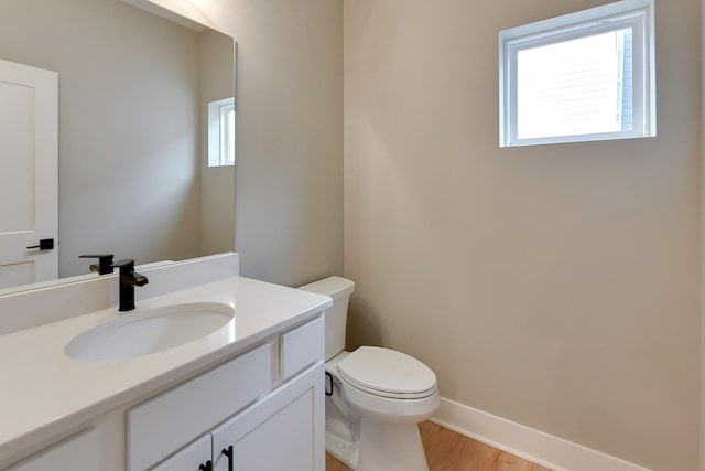 1917 Dahlman Rows Plz, Omaha, NE 68108 - bathroom featuring plenty of natural light, toilet, wood finished floors, and vanity