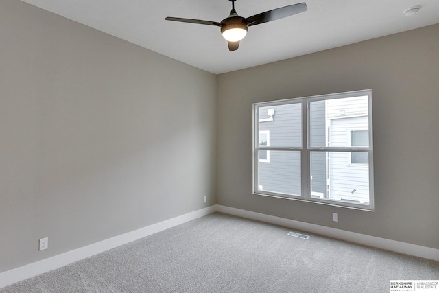 1917 Dahlman Rows Plz, Omaha, NE 68108 - unfurnished room featuring light colored carpet, baseboards, and a ceiling fan