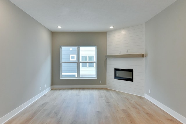 1917 Dahlman Rows Plz, Omaha, NE 68108 - unfurnished living room with a fireplace, light wood-type flooring, baseboards, and recessed lighting