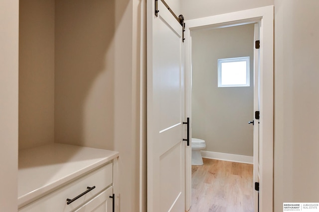 1921 Dahlman Rows Plz, Omaha, NE 68108 - bathroom featuring toilet, wood finished floors, and baseboards