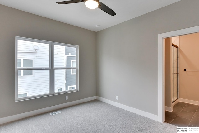 1921 Dahlman Rows Plz, Omaha, NE 68108 - tiled spare room with a ceiling fan, baseboards, and carpet