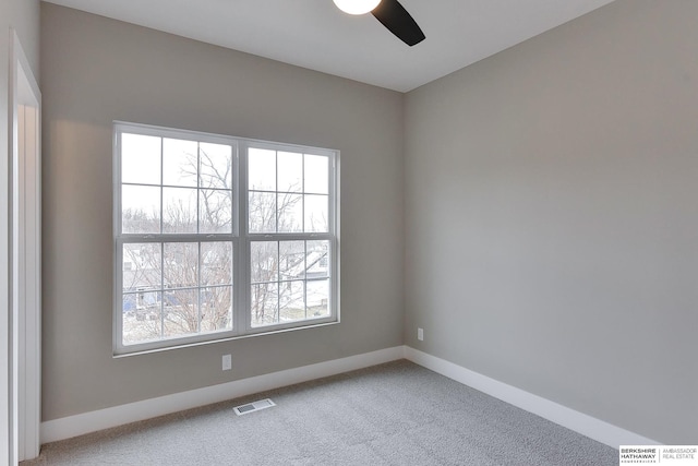 1921 Dahlman Rows Plz, Omaha, NE 68108 - carpeted spare room featuring ceiling fan, baseboards, and healthy amount of natural light