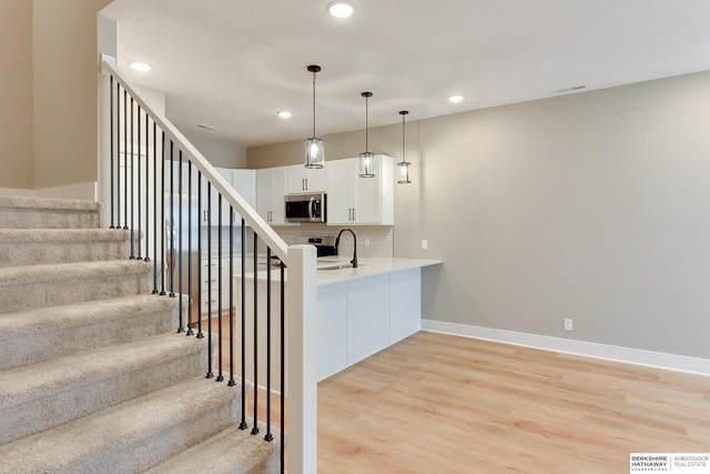 1921 Dahlman Rows Plz, Omaha, NE 68108 - stairs with wood finished floors, recessed lighting, and baseboards