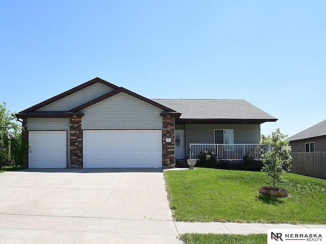 70 Switchgrass Ln, Bennet, NE 68317 - ranch-style home with a garage, a front lawn, driveway, and a porch