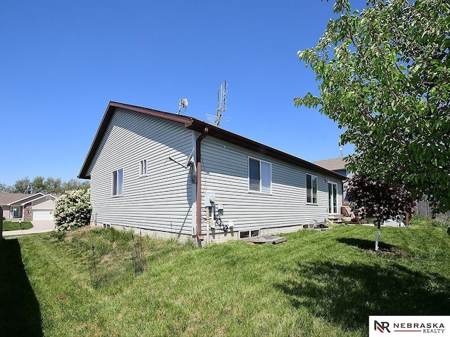 70 Switchgrass Ln, Bennet, NE 68317 - view of side of home featuring a lawn
