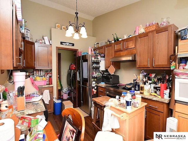 70 Switchgrass Ln, Bennet, NE 68317 - kitchen with under cabinet range hood, light countertops, appliances with stainless steel finishes, dark wood-style floors, and a chandelier