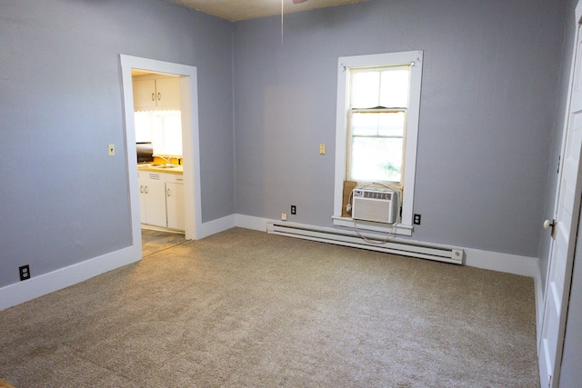547 I St, Pawnee City, NE 68420 - empty room with baseboard heating, light colored carpet, cooling unit, and baseboards