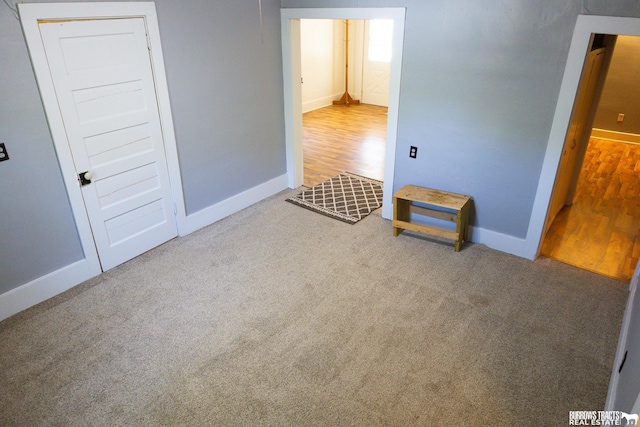 547 I St, Pawnee City, NE 68420 - unfurnished bedroom featuring baseboards, carpet, and wood finished floors