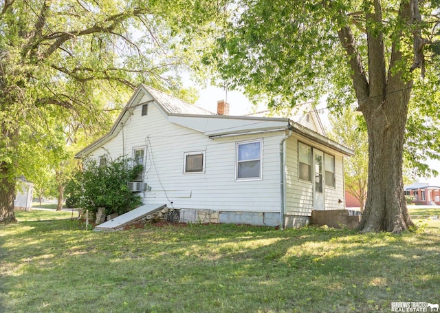547 I St, Pawnee City, NE 68420 - view of property exterior featuring a chimney and a yard
