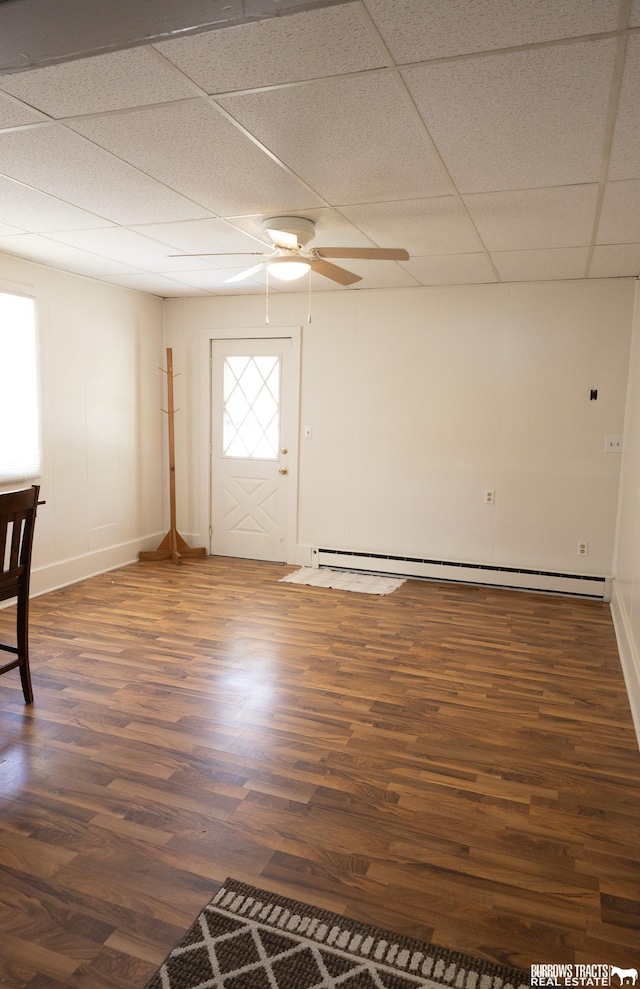 547 I St, Pawnee City, NE 68420 - entryway with dark wood-type flooring, a paneled ceiling, ceiling fan, baseboard heating, and baseboards