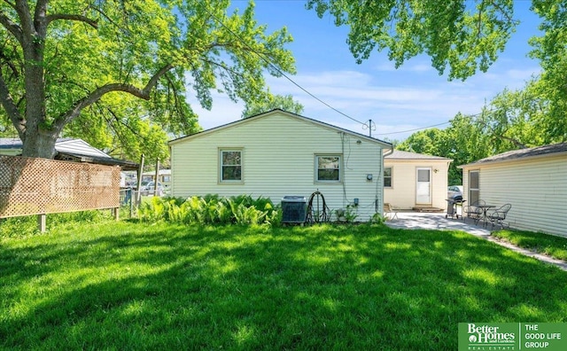 6070 Buckingham Ave, Omaha, NE 68117 - back of property with a patio area, cooling unit, and a yard